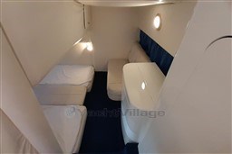 Interior cabin of 2002 Cranchi Smeraldo 37 yacht with twin beds and seating area.