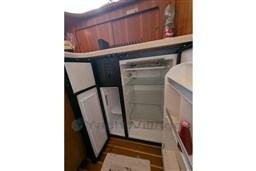 2005 Tiara Yachts 3900 Convertible interior fridge with open doors and wooden cabinetry.