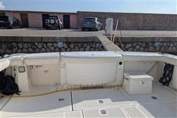 2005 Tiara Yachts 3900 Convertible docked, showcasing spacious deck and marina backdrop.