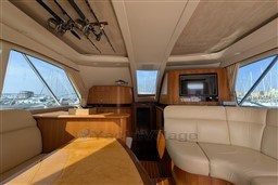 Luxurious interior of 2005 Tiara Yachts 3900 Convertible with leather seating and wood finishes.