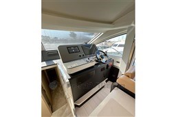 Helm station of 2022 Azimut AZIMUT 68 FLY yacht with modern controls and steering wheel.