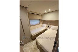 Interior of 2022 Azimut AZIMUT 68 FLY yacht with twin beds and modern design.