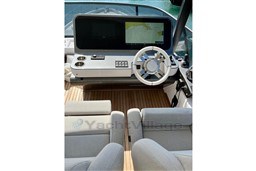 Luxurious helm of 2022 Azimut 68 Fly yacht with modern navigation system.