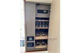 Cabinet with glassware and control panel on Azimut 68 Fly yacht, 2022 model.