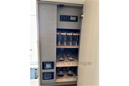 Cabinet with glassware and control panel in 2022 Azimut 68 Fly yacht.