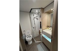 Luxurious bathroom in 2022 Azimut 68 Fly yacht with modern shower and sleek fixtures.