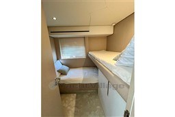 Cozy twin cabin interior on 2022 Azimut 68 Fly yacht, featuring modern design and comfortable bedding.