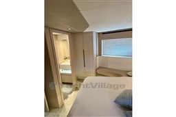 Luxurious interior of 2022 Azimut 68 Fly yacht bedroom with modern design.