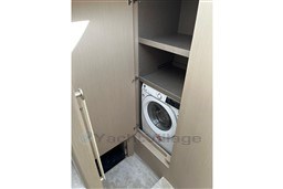 Laundry area with washing machine in 2022 Azimut 68 Fly yacht.