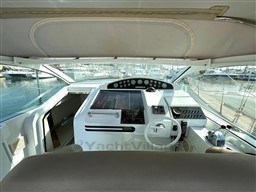 Cockpit of 1993 Pershing 38 yacht with modern controls and marina view.