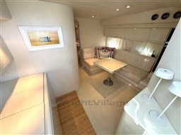 Luxurious interior of a 1993 Pershing 38 yacht with elegant seating and modern decor.