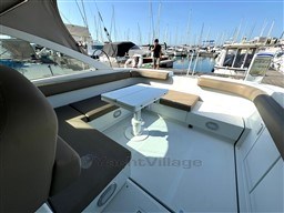 1993 Pershing 38 yacht interior with seating and table, docked at a marina.