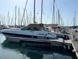 1993 Pershing 38 yacht docked in marina with sailboats in background.