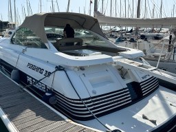 1993 Pershing 38 yacht docked at marina, featuring sleek design and covered cockpit.