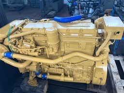 Yellow marine engine for a 1993 Pershing 38 boat, displayed in a workshop.