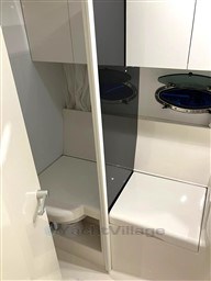 Interior of 1993 Pershing 38 yacht bathroom with modern fixtures and porthole windows.