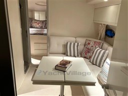 Interior of 1993 Pershing 38 yacht with cozy seating and decorative pillows.