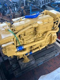 Yellow engine on wooden pallet, Pershing 38 model, 1993, in a workshop setting.