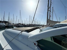 1993 Pershing 38 yacht docked in a sunny marina with sailboats.