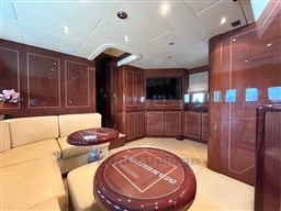 Luxurious interior of 2005 Mangusta 72 Open yacht with elegant wood paneling and plush seating.