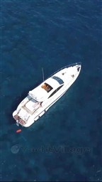 Aerial view of 2005 Mangusta 72 Open yacht on clear blue water.