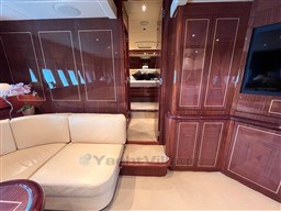 Luxurious interior of 2005 Mangusta 72 Open yacht with elegant wood paneling and plush seating.