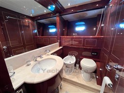 Luxurious bathroom interior of 2005 Mangusta 72 Open yacht with elegant wood finish.