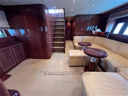 Luxurious interior of a 2005 Mangusta 72 Open yacht with elegant wood finishes.