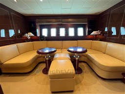 Luxurious interior of 2005 Mangusta 72 Open yacht with elegant seating and tables.