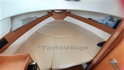 Interior cabin of 2008 Jeanneau Cap Camarat 755 WA with beige cushions and wooden accents.