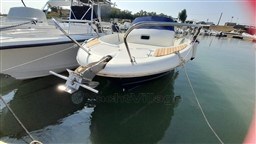 2008 Jeanneau Cap Camarat 755 WA boat docked in marina, front view.
