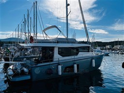 2019 Cranchi ECO Trawler 43 Long Distance docked in a marina under a blue sky.