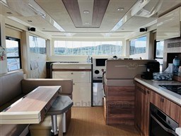 Interior of 2019 Cranchi ECO Trawler 43, featuring modern kitchen and seating area.