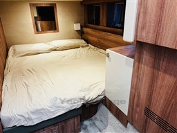 Cozy bedroom in 2019 Cranchi ECO Trawler 43 Long Distance yacht with wood accents.