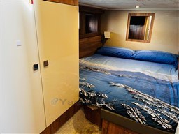 2019 Cranchi ECO Trawler 43 cabin with nautical-themed bedding and modern wood finishes.