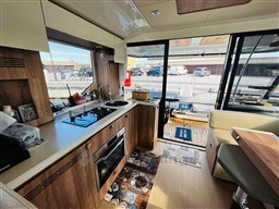 Interior of 2019 Cranchi ECO Trawler 43, featuring modern kitchen and seating area.