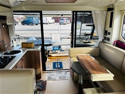 Interior of 2019 Cranchi ECO Trawler 43, featuring modern kitchen and seating area.