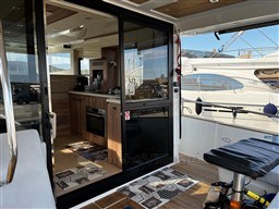 Interior view of 2019 Cranchi ECO Trawler 43, showcasing modern kitchen and seating area.