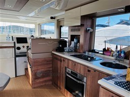 Interior of 2019 Cranchi ECO Trawler 43, featuring modern kitchen and helm station.
