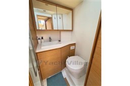 Modern bathroom in 2024 Solaris 50 yacht with wooden cabinetry and sleek fixtures.
