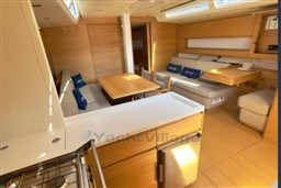 Luxurious interior of 2024 Solaris 50 yacht with modern kitchen and cozy seating area.
