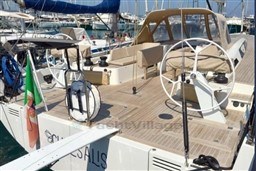 2024 Solaris 50 yacht with dual steering wheels and spacious deck in marina.