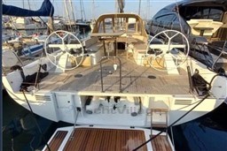 2024 Solaris 50 yacht with dual steering wheels, docked in a marina.