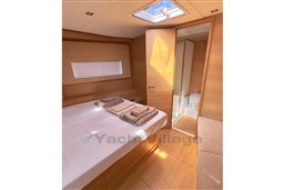 Luxurious interior of 2024 Solaris 50 yacht cabin with bed and ensuite bathroom.