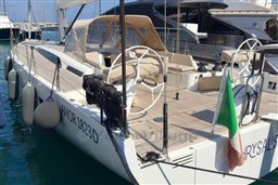 2024 Solaris 50 yacht docked, featuring dual steering wheels and Italian flag.