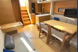 Luxurious interior of 2024 Solaris 50 yacht with modern dining area and wooden finishes.