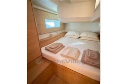 Luxurious cabin interior of 2024 Solaris 50 yacht with neatly arranged bedding.