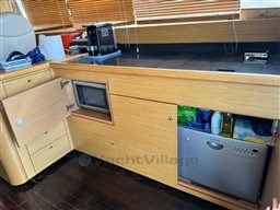 Modern kitchen area in 2007 Innovazione e Progetti Alena 48 yacht with appliances and storage.