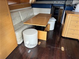 Interior of 2007 Innovazione e Progetti Alena 48 yacht with wooden table and seating.