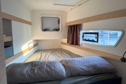 Cozy cabin interior of 2024 Fountaine Pajot Isla 40 catamaran with window views.
